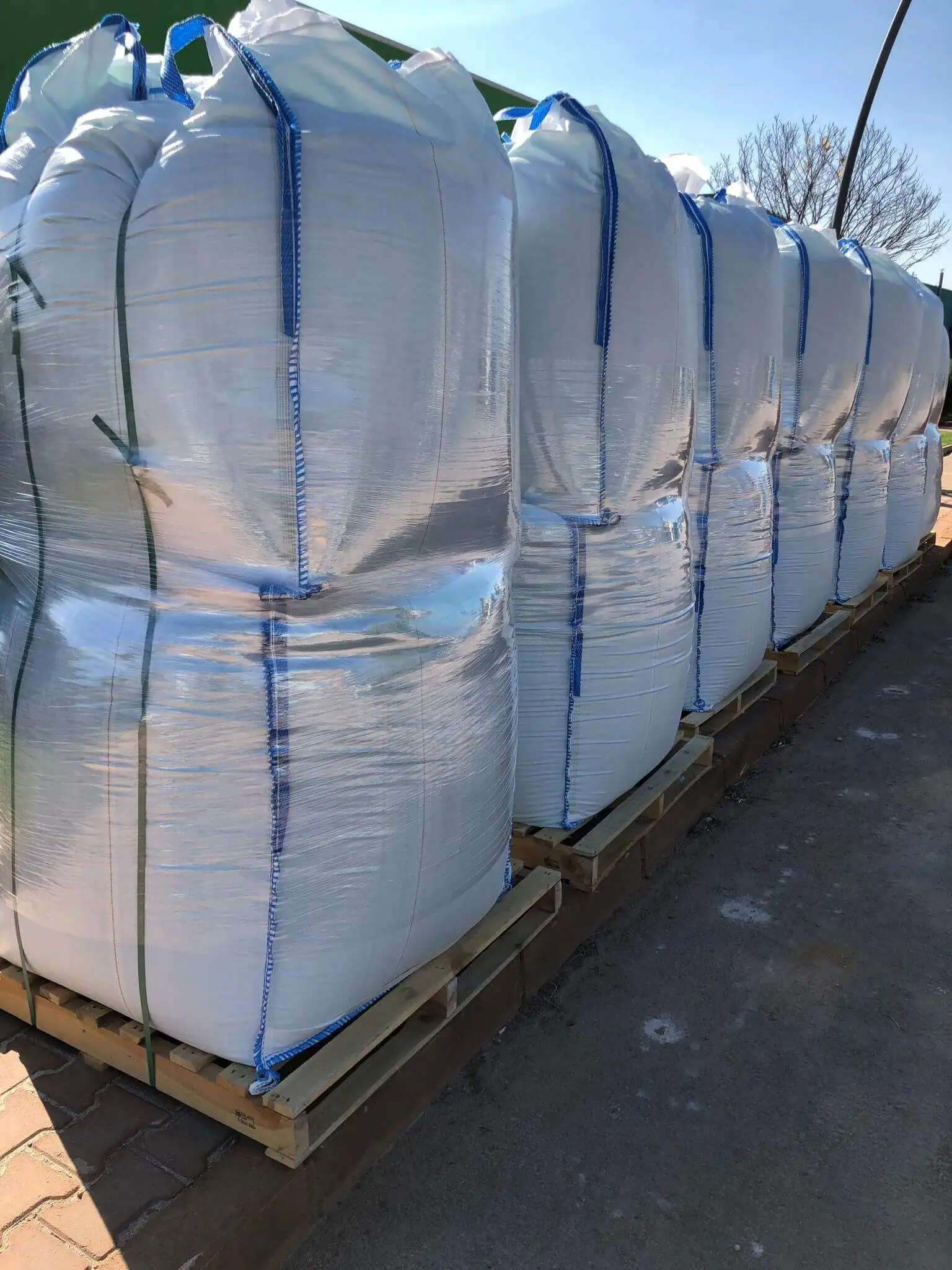 Palletized big bags of ferrous sulfate heptahydrate prepared for loading